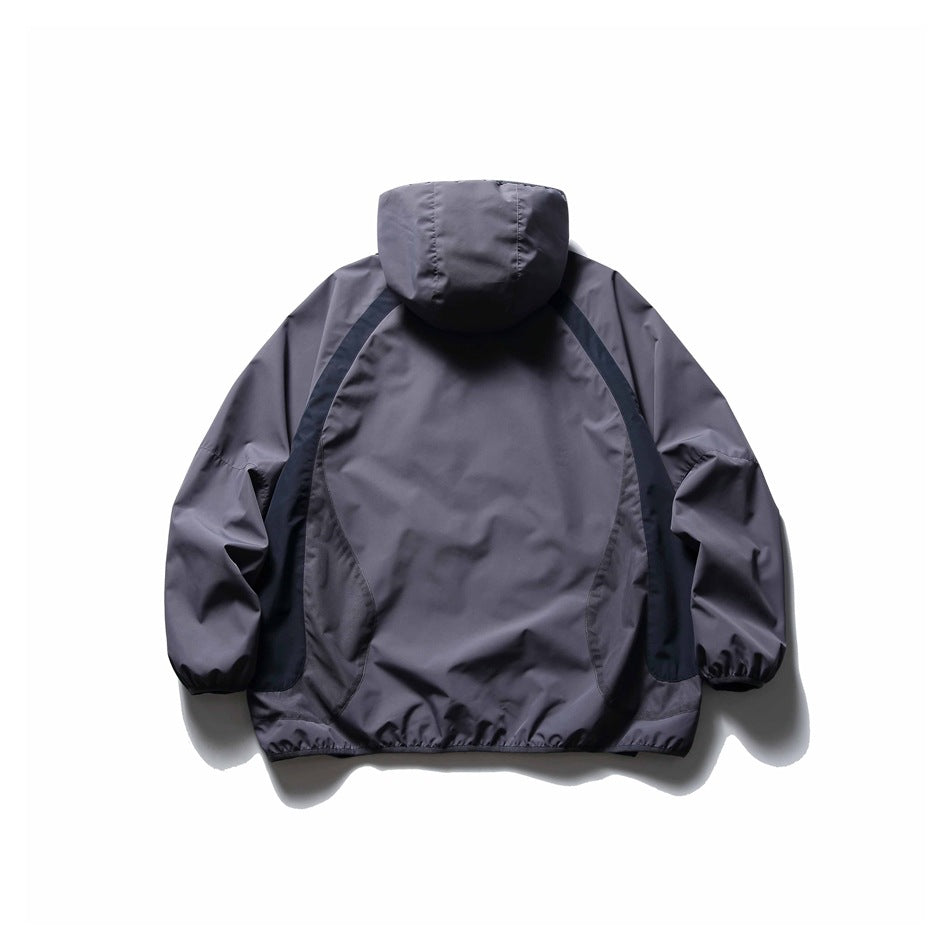 Back view of a charcoal-gray hooded jacket with dark curved contrast panels and gathered cuffs and hem.