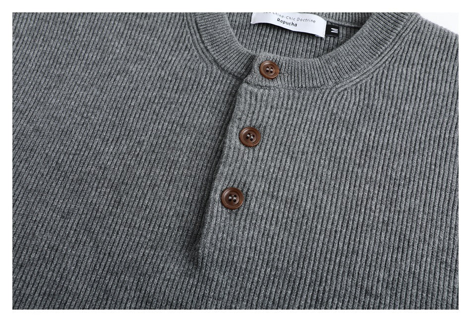 Close-up of the gray rib-knit cardigan's neckline and three brown buttons.