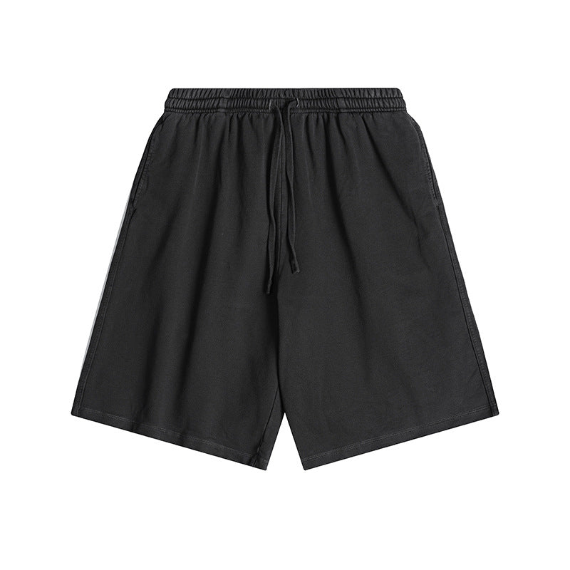Black washed-look knee-length drawstring shorts with elastic waistband, flat lay front view