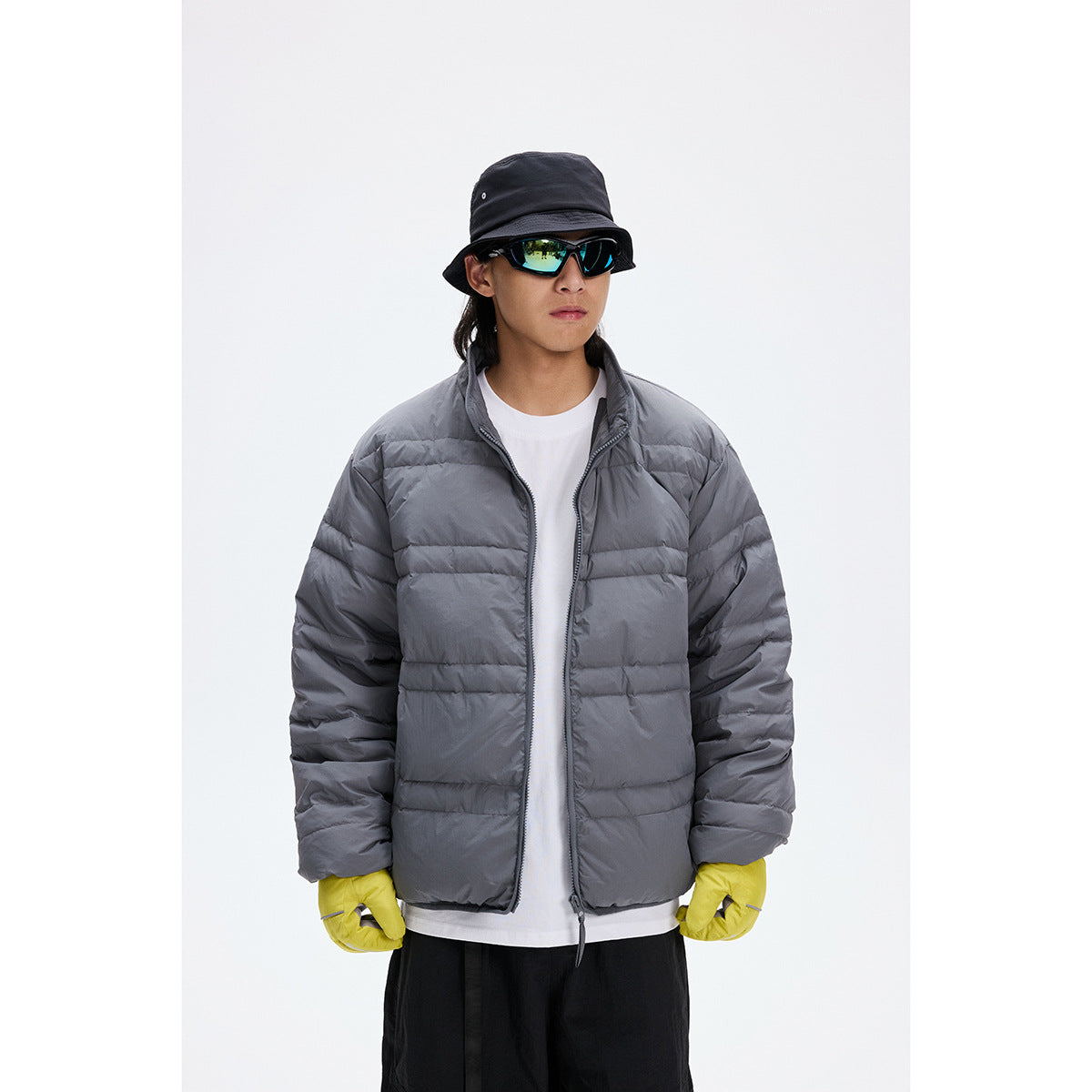 Model wearing a gray quilted jacket with a stand collar, shown from the front.
