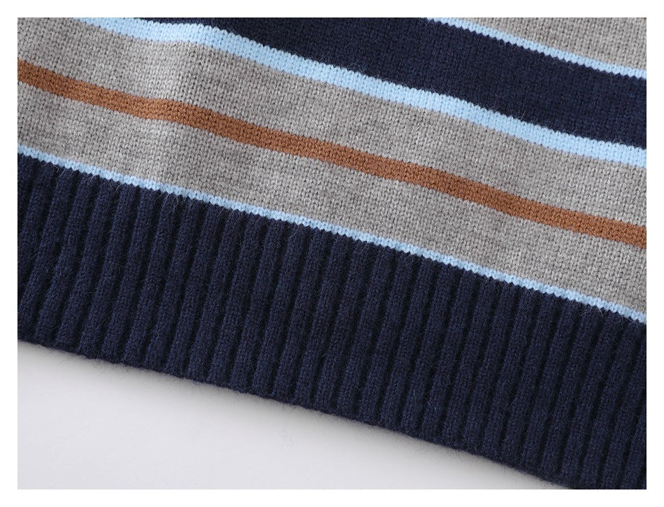 Close-up of the sweater's ribbed navy hem and gray, pale blue, and rust stripe pattern.