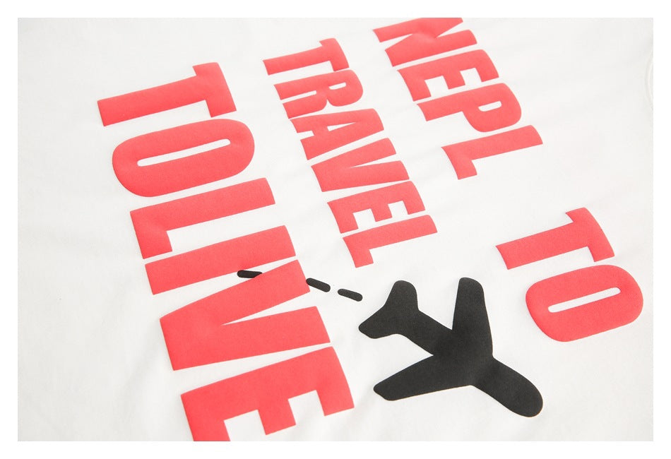 Close-up of a white shirt’s bold red lettering and black airplane graphic.