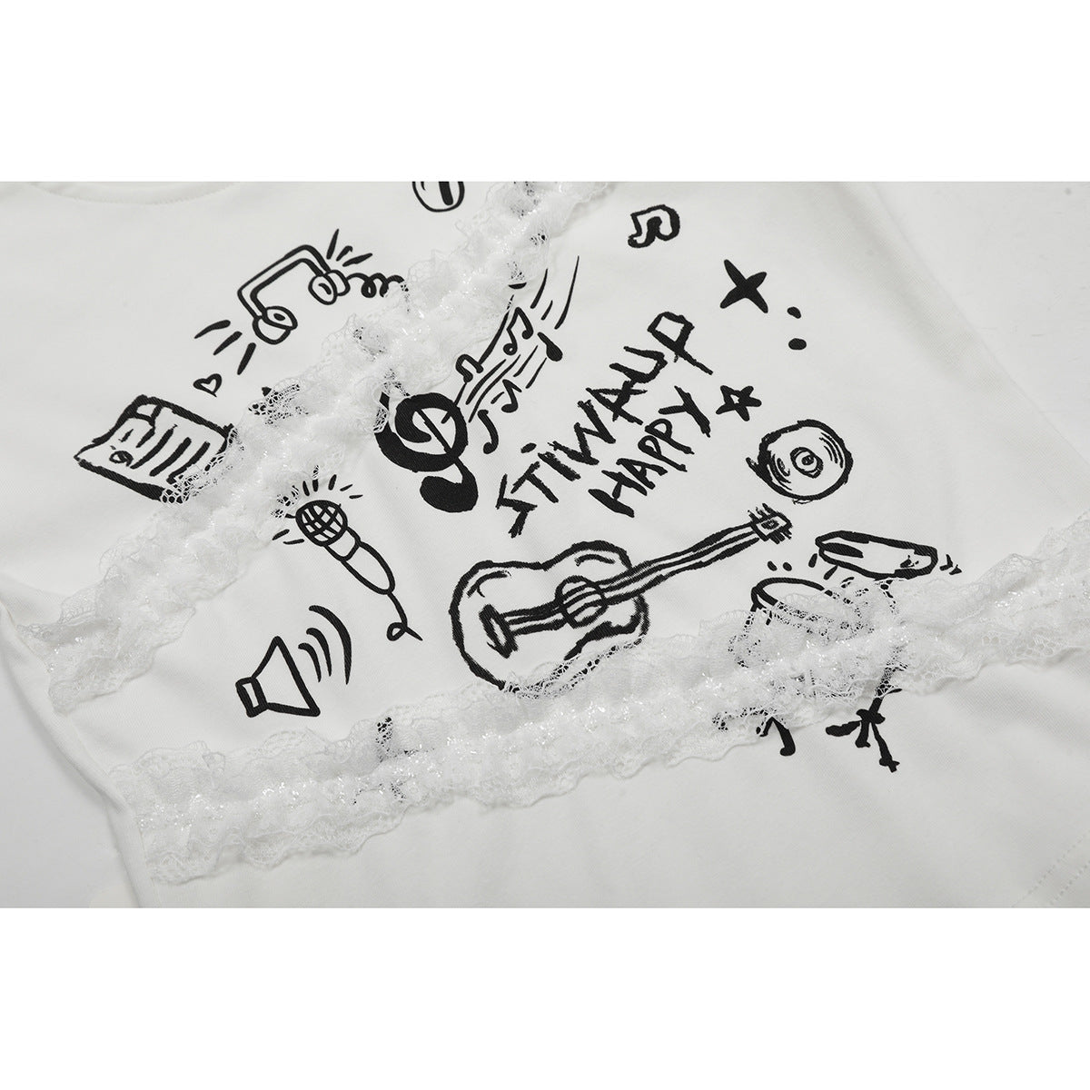 Close-up of a white T-shirt with black music-themed illustrations and decorative white lace trim.