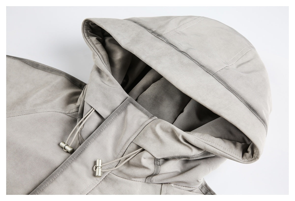 Close-up of a light gray jacket hood with stitched panels and adjustable drawcords with metal toggles.