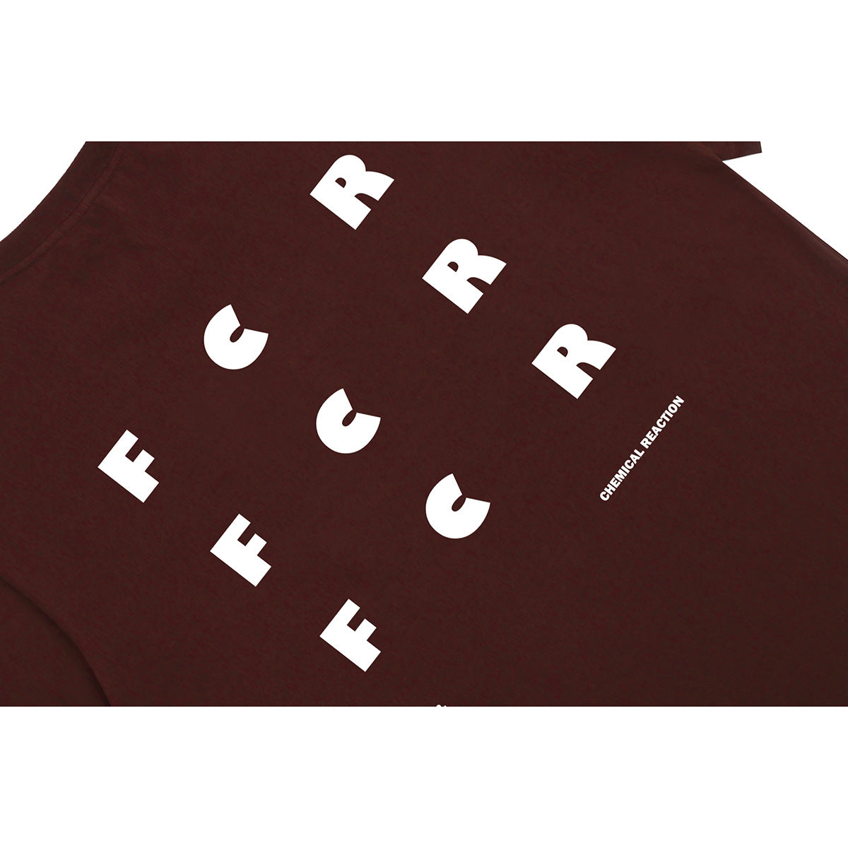 Close-up of a burgundy T-shirt with oversized white letter graphics and small text.