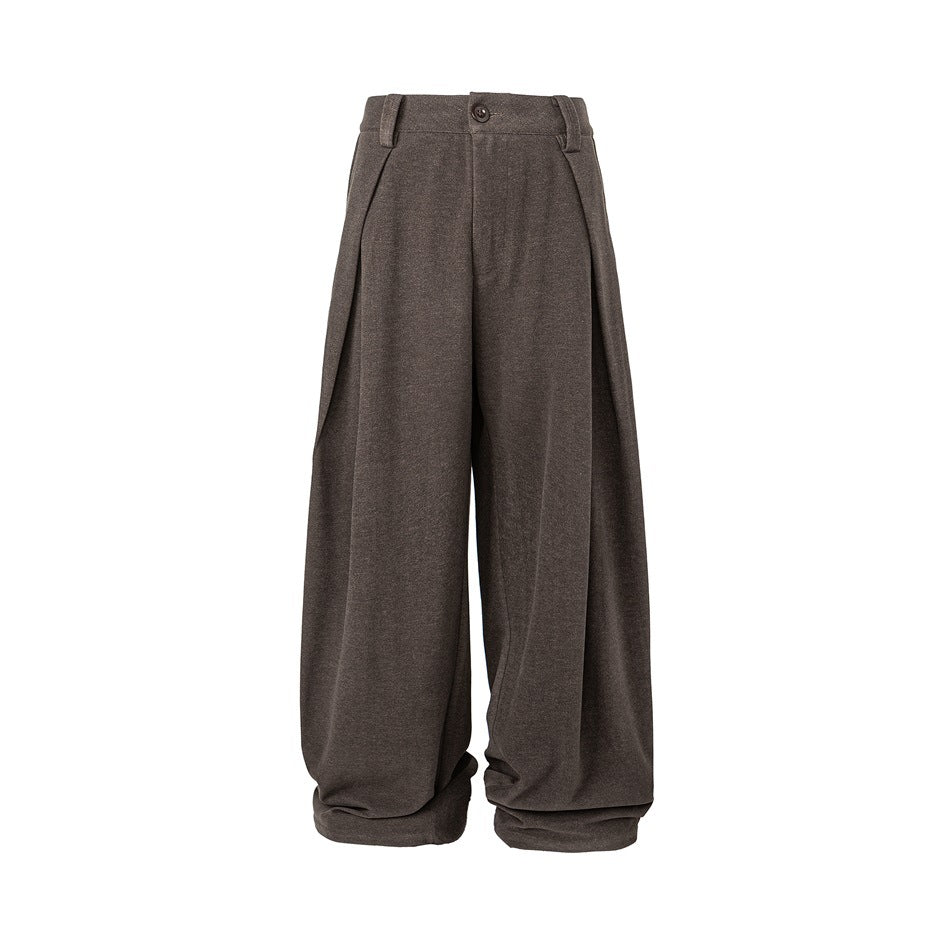 Brown wide-leg pleated trousers flat front view with button closure, belt loops, side-folding pleats and gathered hems