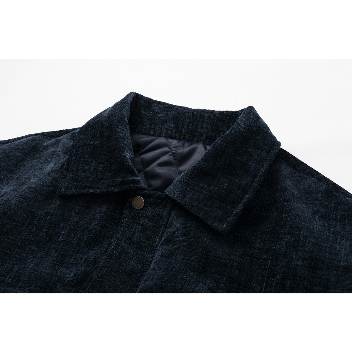 Close-up of a dark navy jacket's wide collar, snap button, and quilted inner lining.