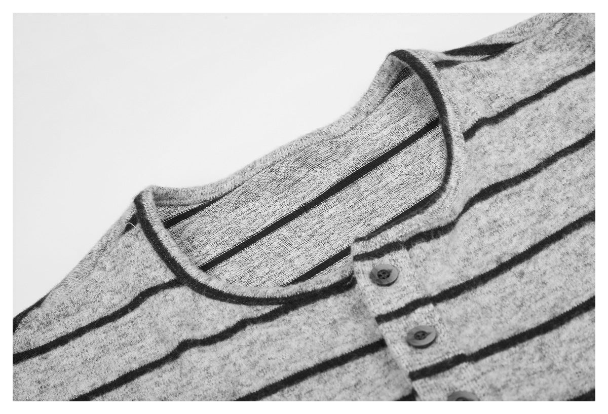 Close-up of the gray striped shirt's rounded neckline and short button placket.