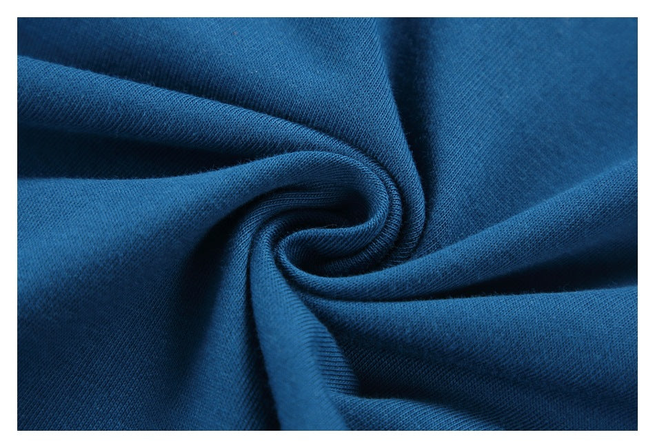 Close-up of blue garment fabric gathered into a spiral fold, showing its texture.