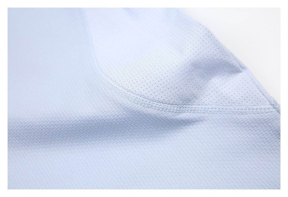 Close-up of a light blue shirt's perforated panel and stitched seam.