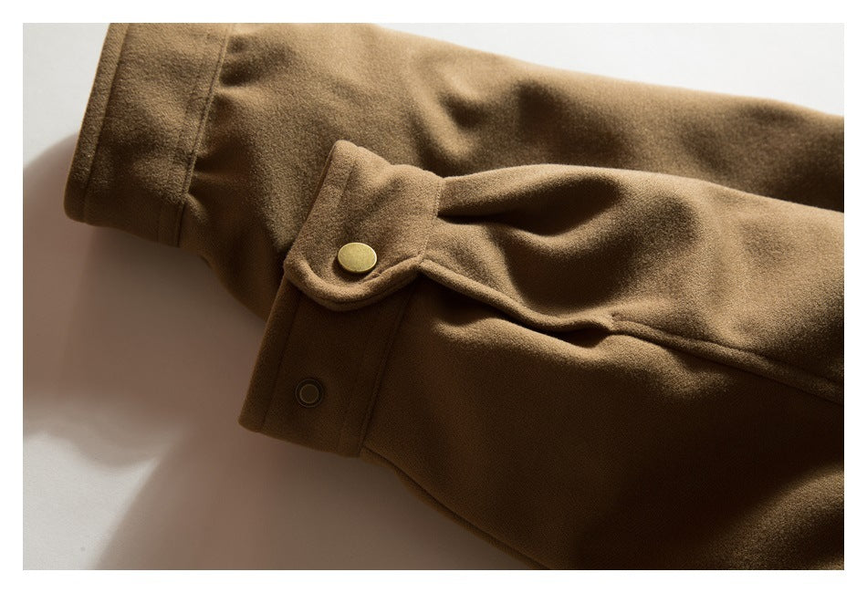 Close-up of a brown jacket sleeve cuff with a snap tab and metal button.