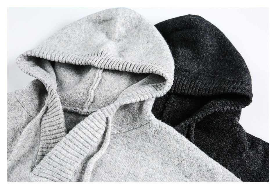Close-up of light gray and charcoal hooded sweaters, showing their ribbed hood edges.