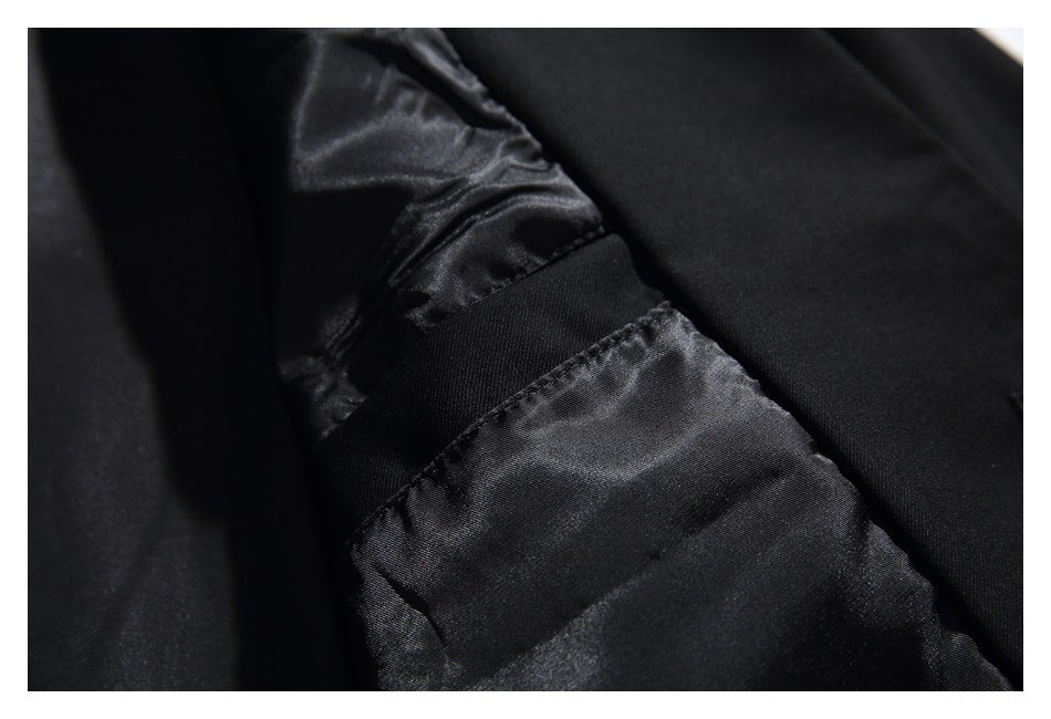 Close-up of black garment lining with a stitched seam and a wide fabric band.