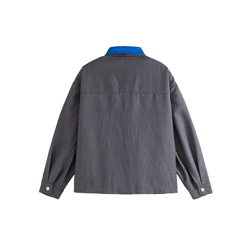 Back view of a charcoal-gray jacket with a bright blue collar and buttoned cuffs.
