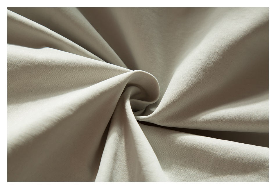 Close-up of light beige fabric draped into folds.