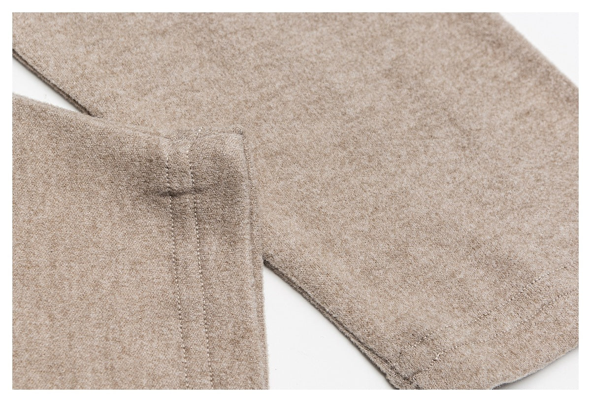 Close-up of the taupe top's sleeve and stitched cuff edge.