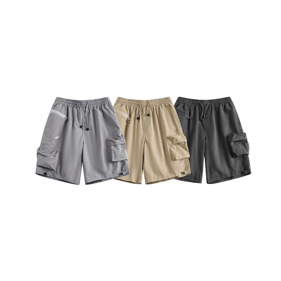 Three cargo shorts shown from the front in gray, tan, and charcoal, with drawstrings and roomy side pockets.