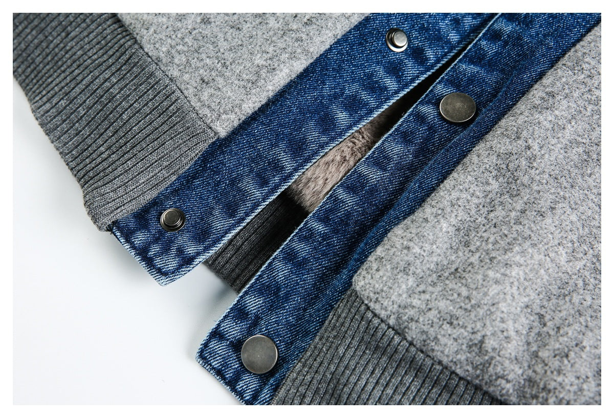 Close-up of blue denim trim with metal snaps and gray ribbed cuffs on a gray jacket.