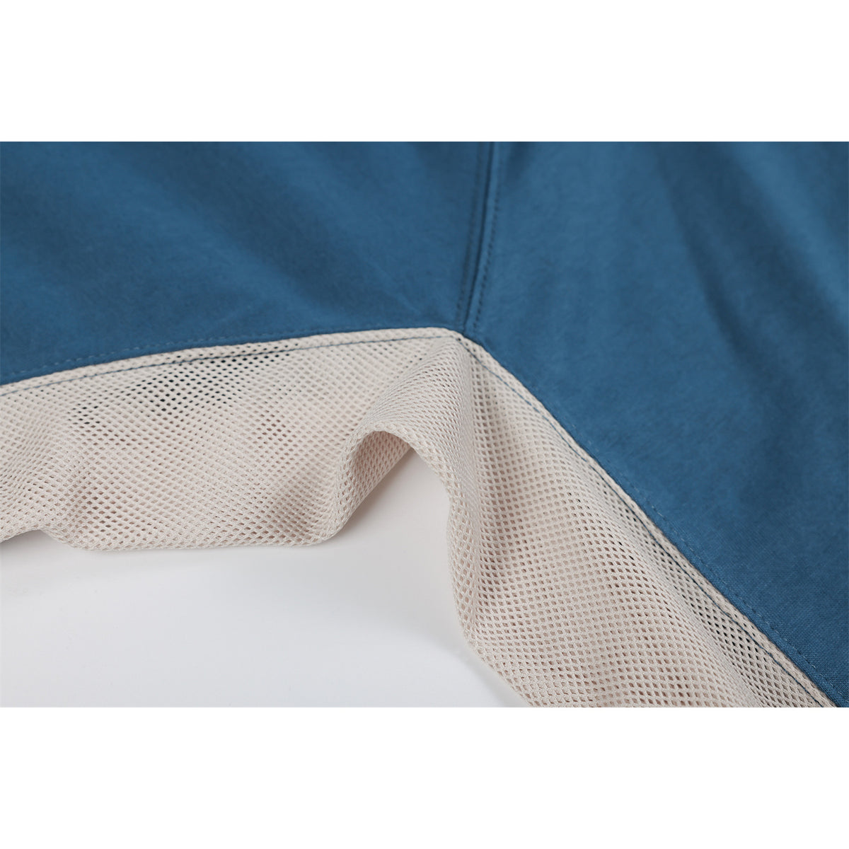 Close-up of the blue top's inside seam and light-colored mesh panel.