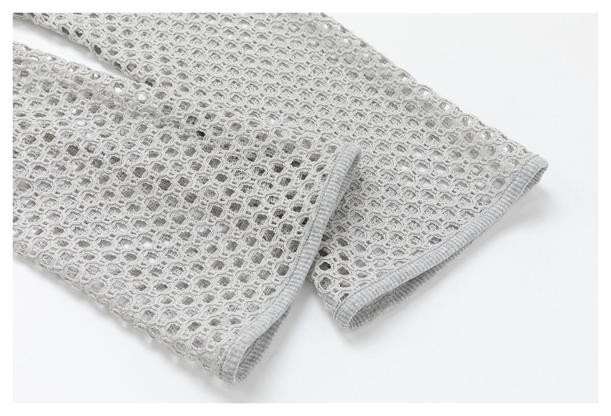Close-up of a light gray openwork sleeve with a ribbed cuff.