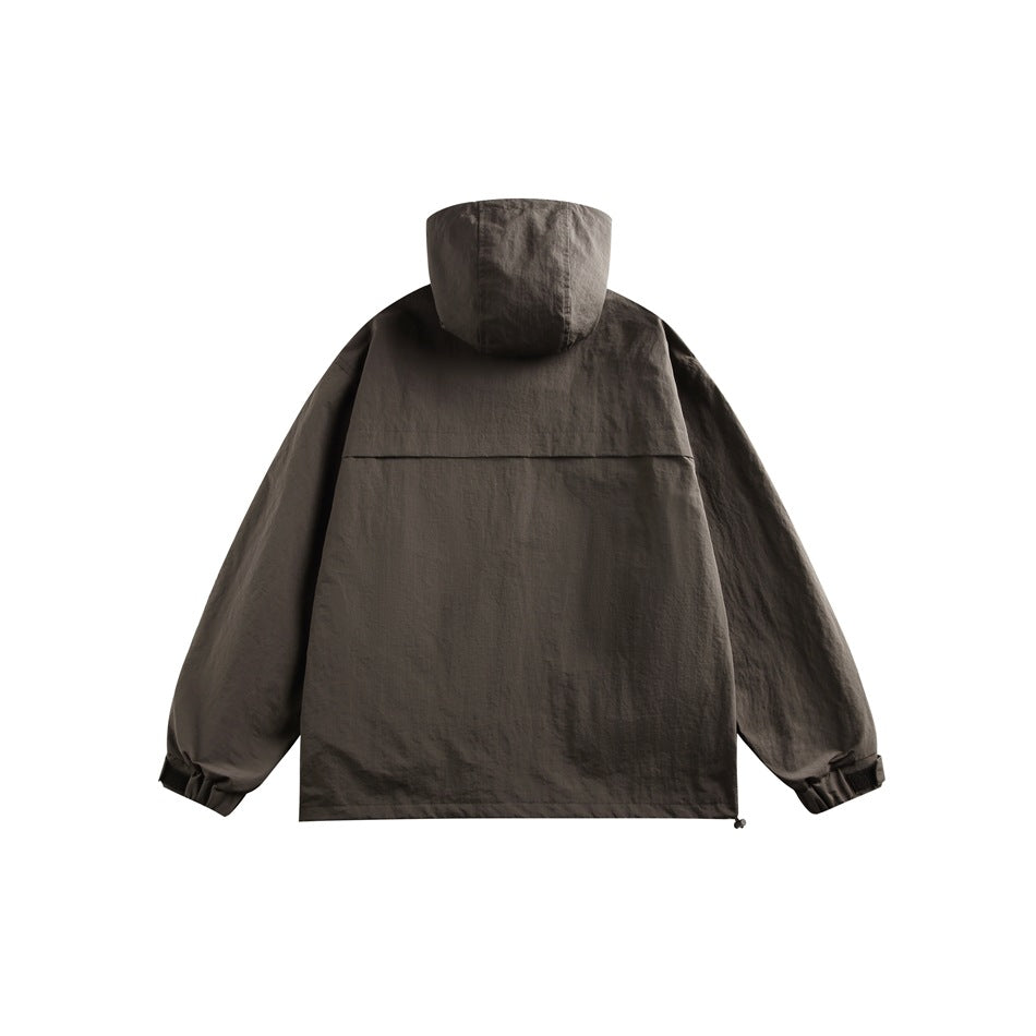 Back view of a dark charcoal hooded jacket with a wide back yoke and adjustable cuffs.