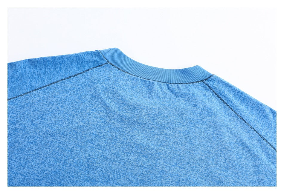 Close-up of a blue heathered garment's ribbed crew neck and raglan shoulder seams.