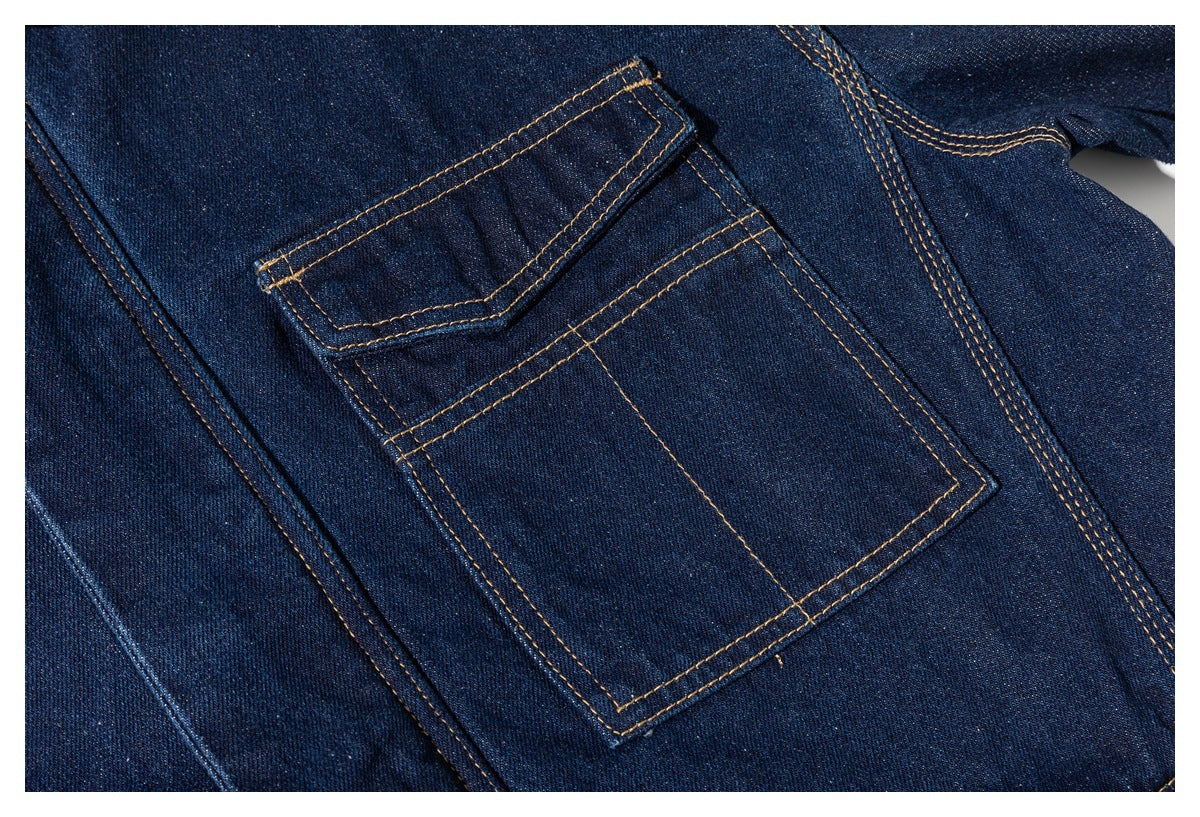Close-up of a dark indigo denim patch pocket with contrasting tan double stitching.
