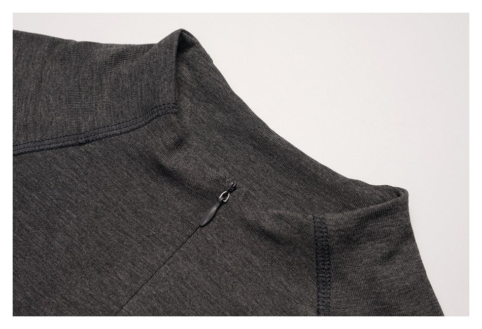 Close-up of a charcoal top's neckline, shoulder seam, and small zipper.