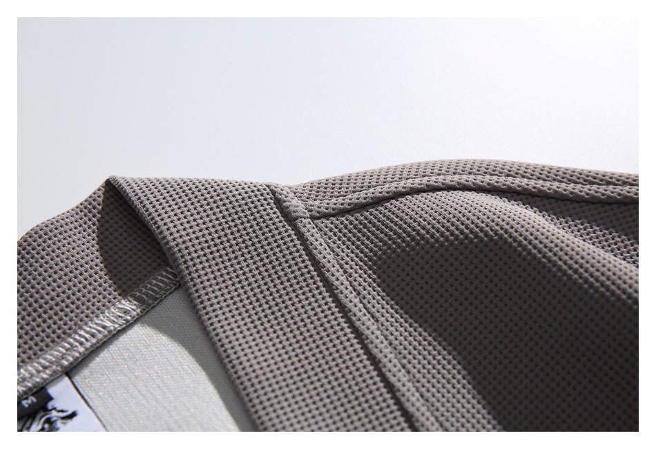 Close-up of the gray jacket's textured fabric, collar, and inner neck label.