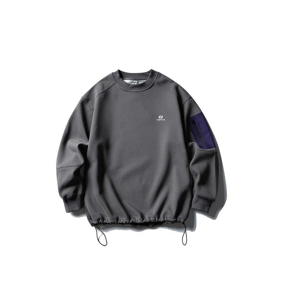 Gray crewneck sweatshirt flat lay with purple zippered sleeve pocket and drawcord hem