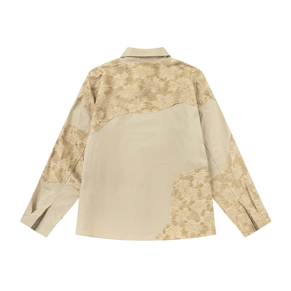 Back of a beige long-sleeve button-up shirt with irregular tan textured panels on a white background.