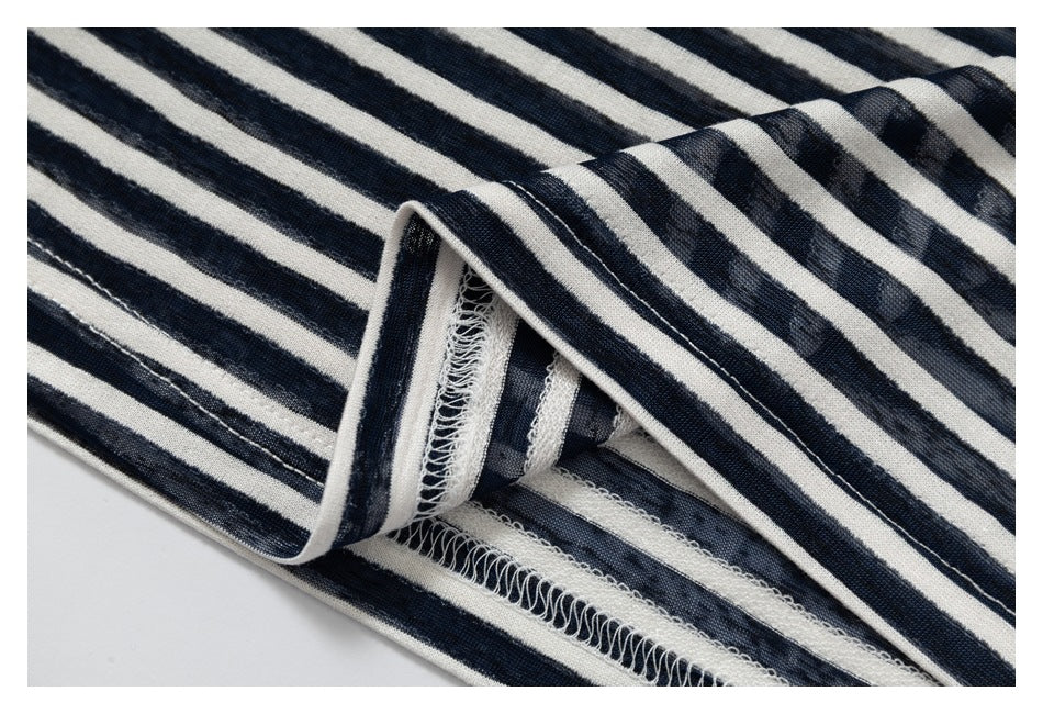 Close-up of the overlocked inside seam and edge of navy and cream striped fabric.