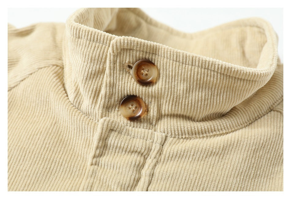 Close-up of the beige jacket's ribbed stand collar and two brown buttons.