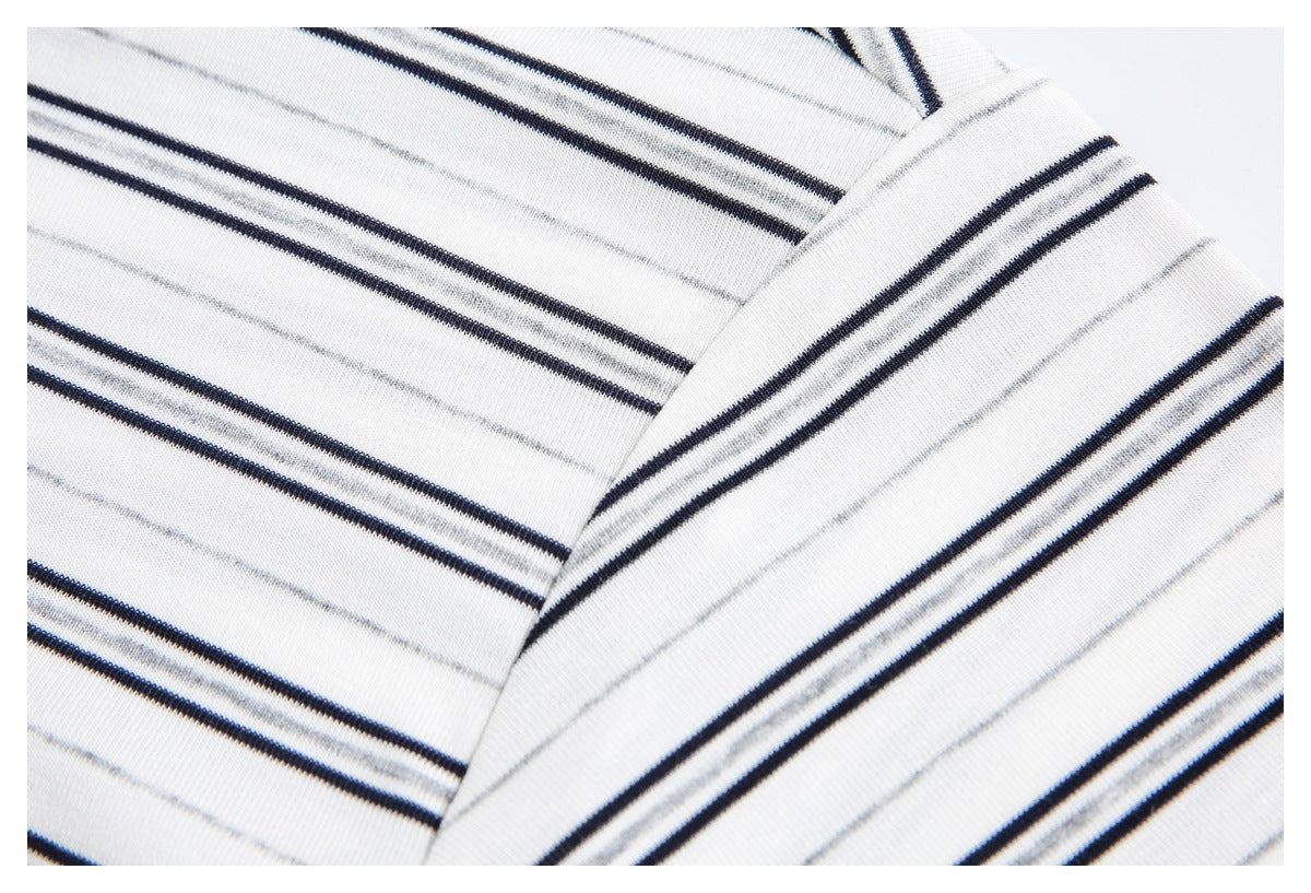 Close-up of the white polo shirt's collar edge and striped fabric, showing black and gray lines.