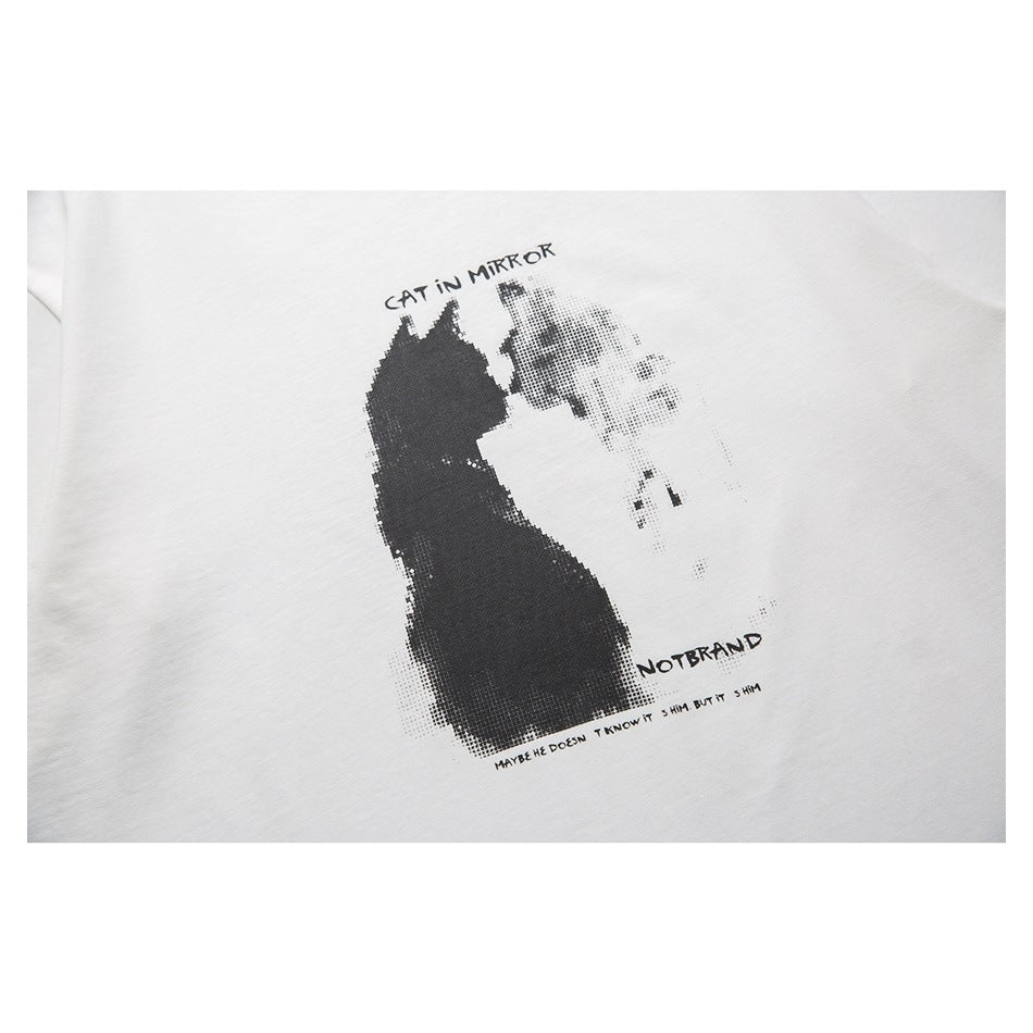 Close-up of a black cat and reflection graphic with lettering printed on a white T-shirt.