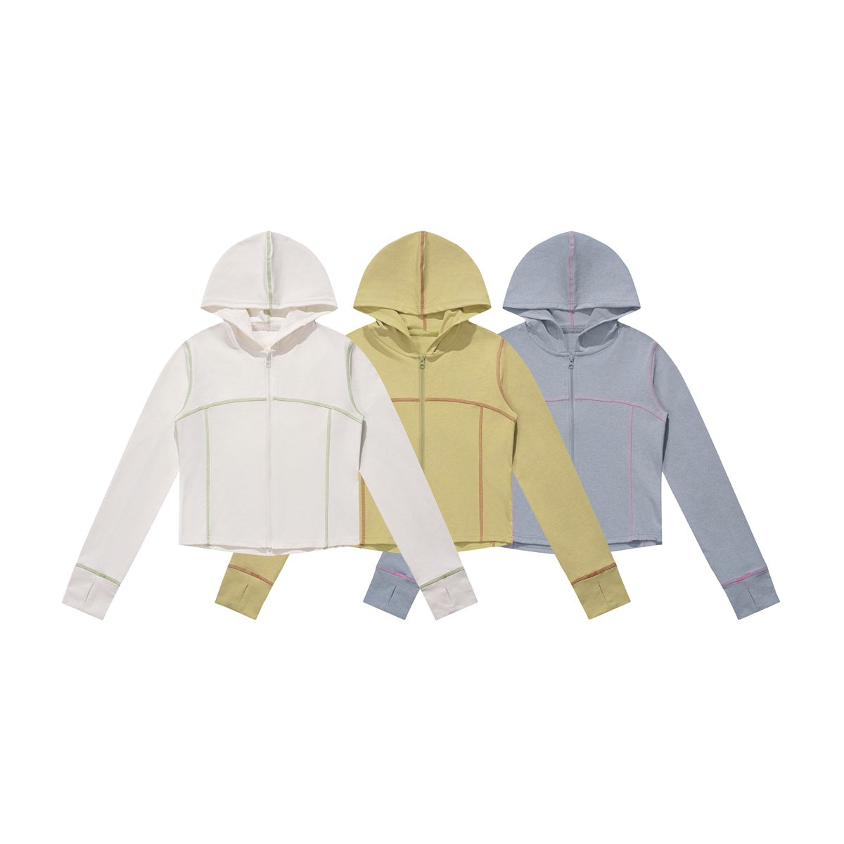 Three cropped zip hoodies shown from the front in off-white, pale yellow, and blue-gray with contrasting seams.