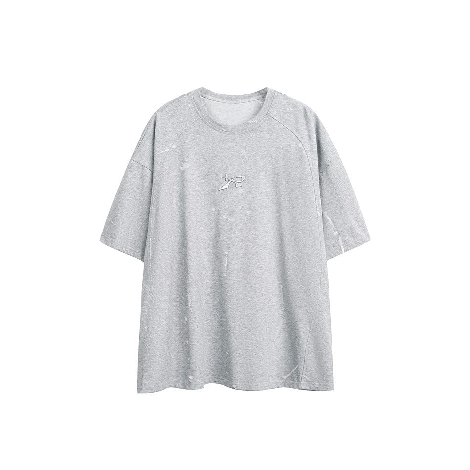 Gray short-sleeve crew-neck T-shirt with faint splatter marks and small embossed logo at center chest, flat front view