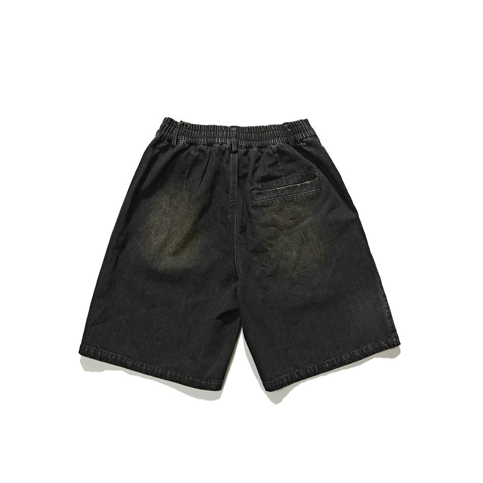Back view of black denim shorts with a gathered elastic waistband and a single welt pocket.