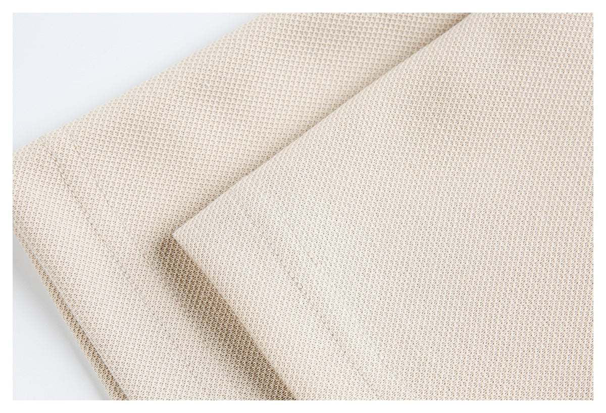 Close-up of overlapping cream-beige fabric panels with stitched seams.