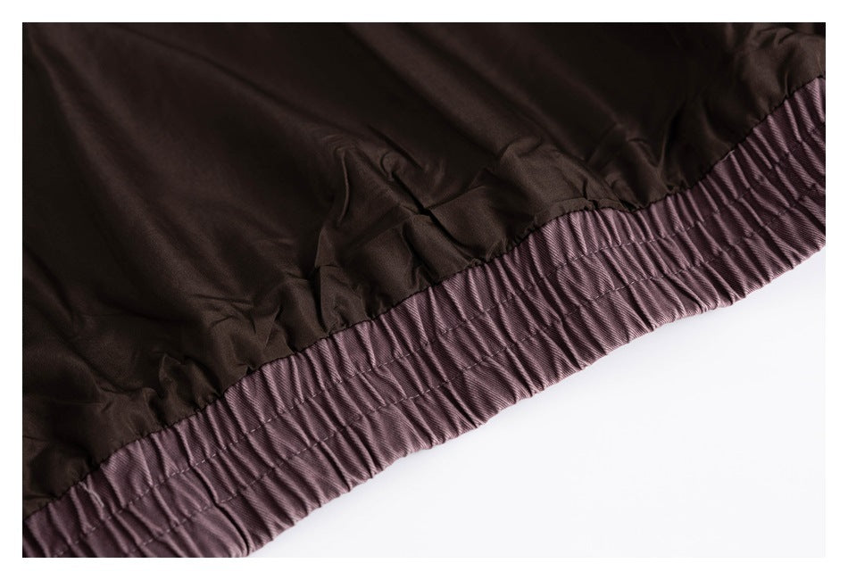 Close-up of the dark lining and gathered plum elastic waistband of a garment.