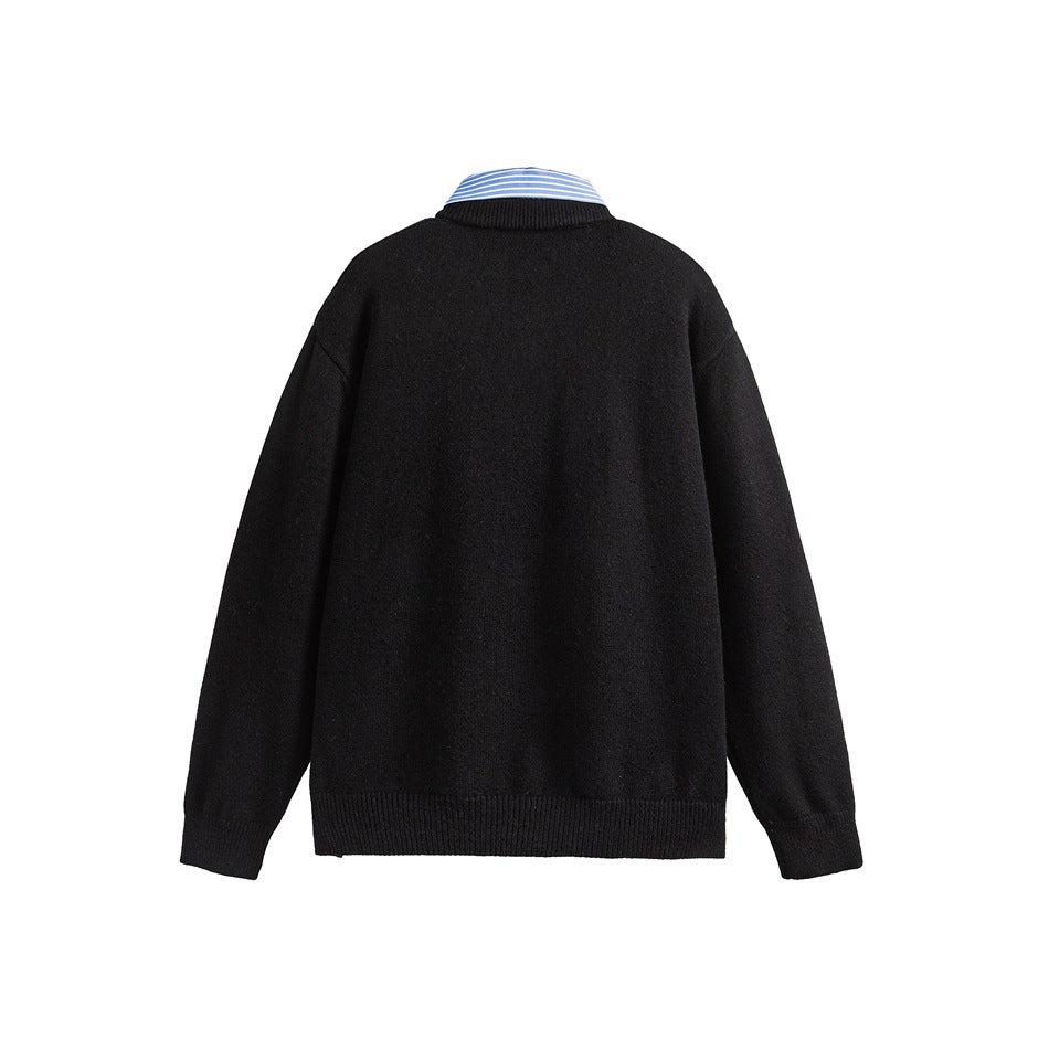 Back view of a black long-sleeve sweater with ribbed cuffs and hem; a blue striped shirt collar shows above it.