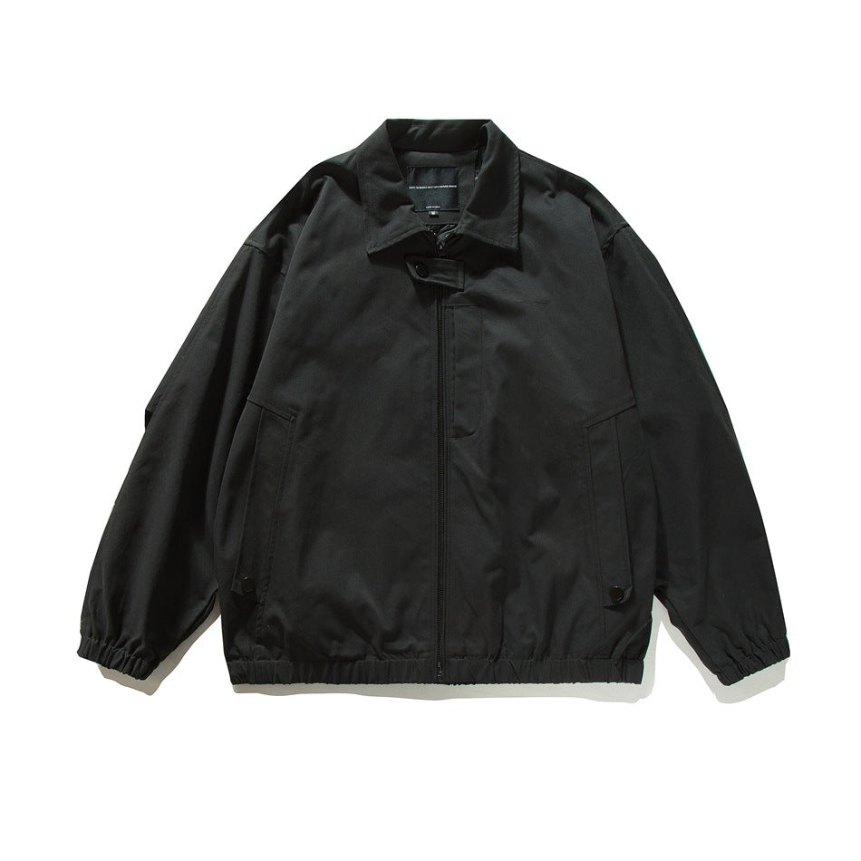 Black zip-front bomber-style jacket flat lay with pointed collar, slanted pockets, snap tabs and elastic cuffs and hem