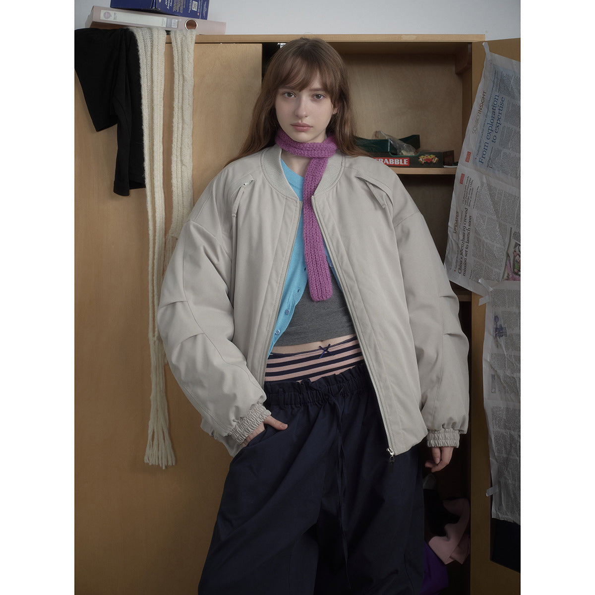 Model wearing a light gray oversized zip-front bomber jacket with gathered cuffs and a ribbed collar.