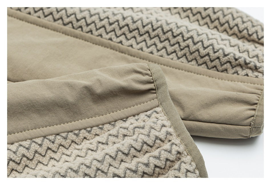 Close-up of beige garment panels with taupe zigzag-patterned fabric and a stitched seam.