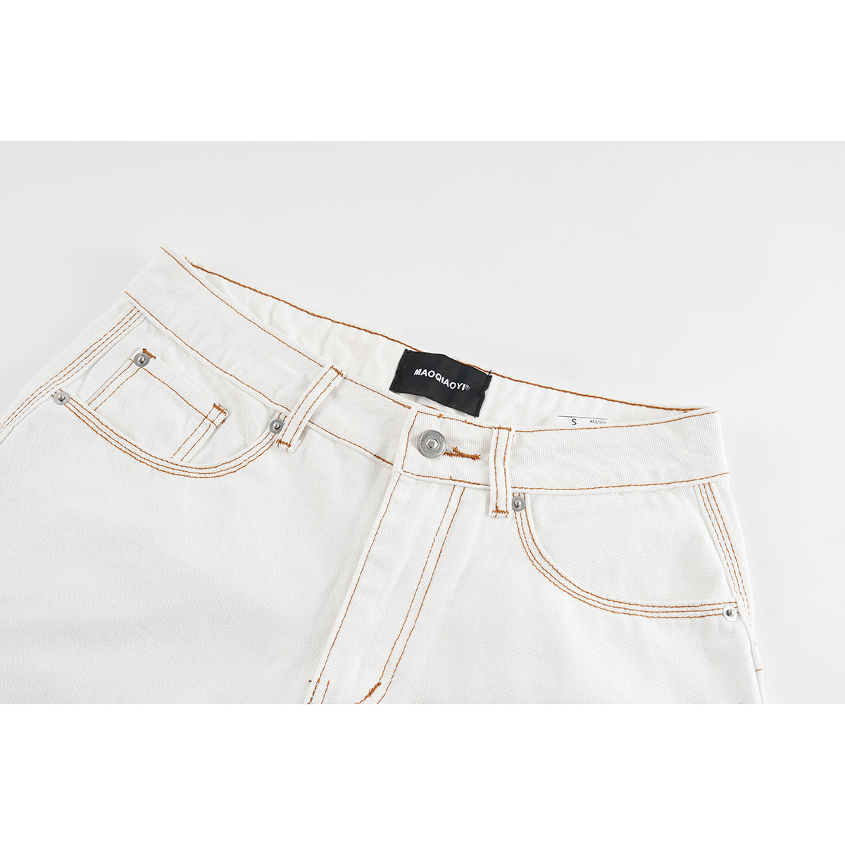Close-up of white denim shorts showing the waistband, button, front pockets, and orange-brown stitching.