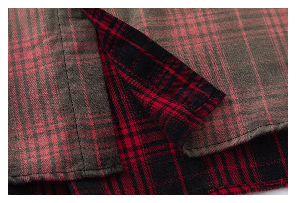 Close-up showing the red-and-black plaid shirt fabric folded back to reveal its lighter reverse side.
