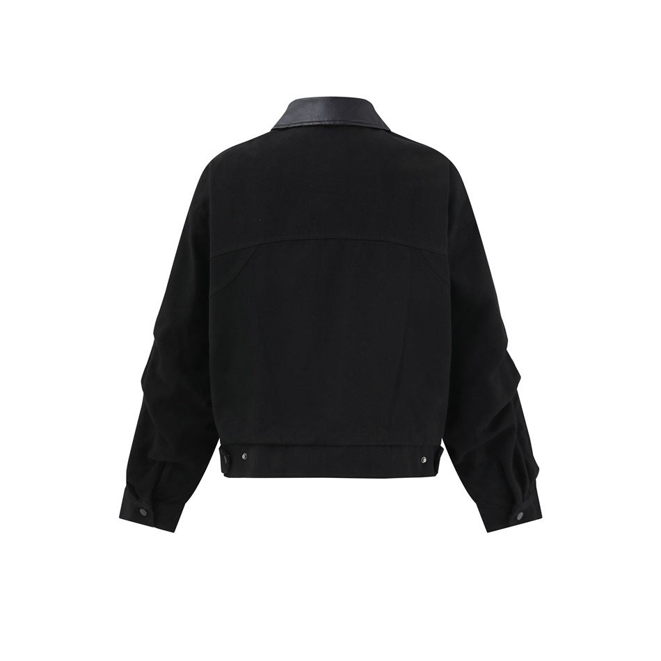 Back view of a black jacket with a glossy collar, curved back yoke, snap cuffs, and a snap-detail hem.