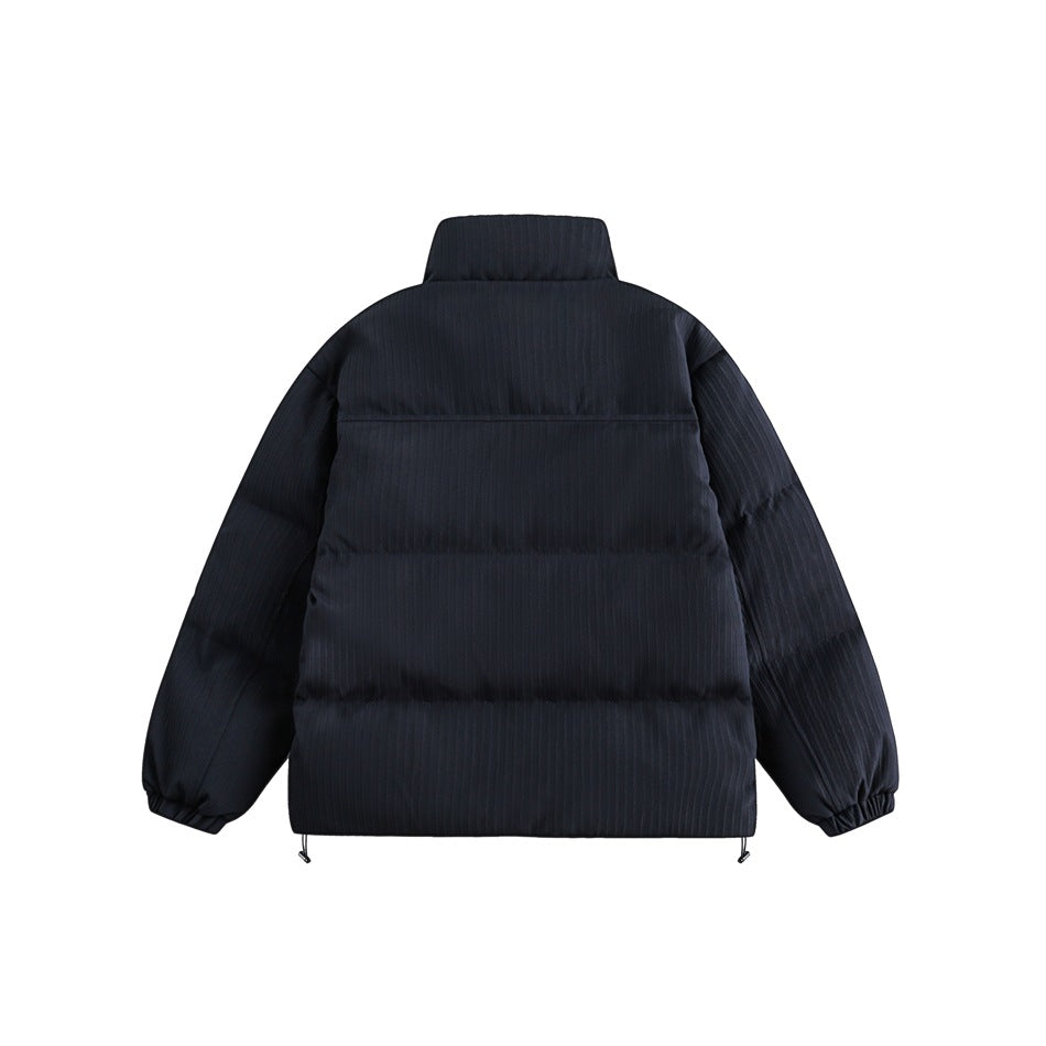 Back view of a dark navy quilted jacket with a high collar, elastic cuffs and adjustable hem cords.