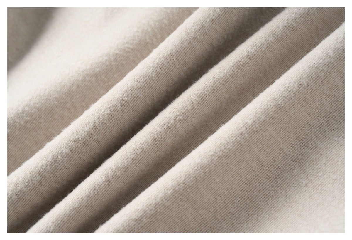 Close-up showing the fine surface texture and folds of light beige fabric.