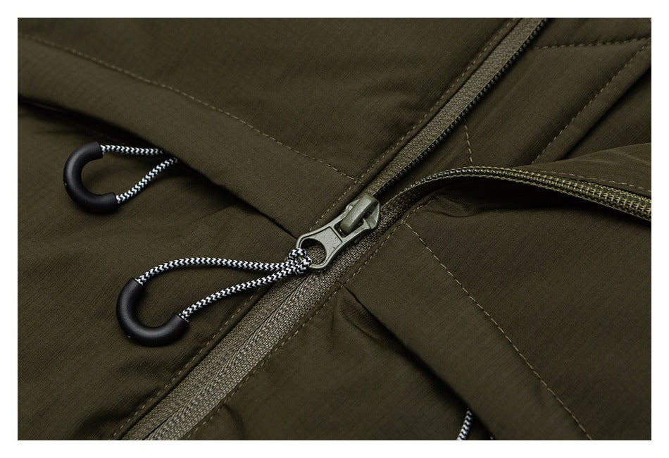Close-up of the olive jacket's zipper slider, cord pulls, and overlapping front flap.